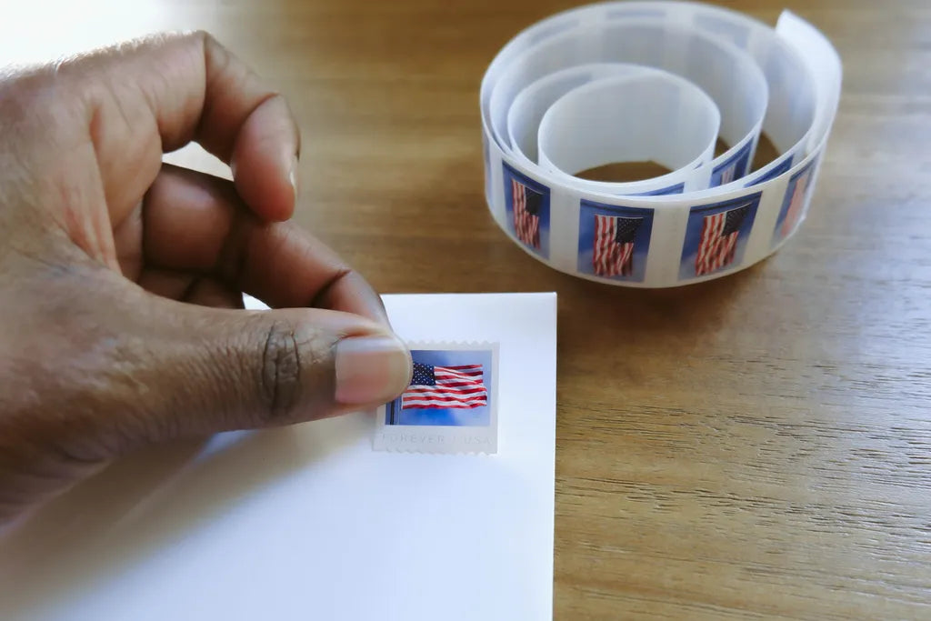 Applying a US flag postage stamp